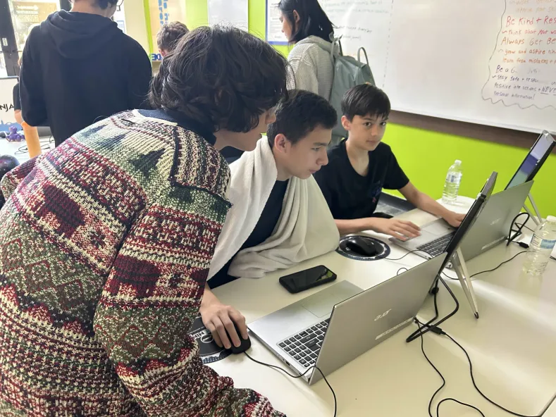 Lance, Jaxson, and Kingston working on their project at Counterspell.