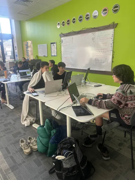 Lance, Jaxson, and Kingston putting the final touches on their project at Counterspell.