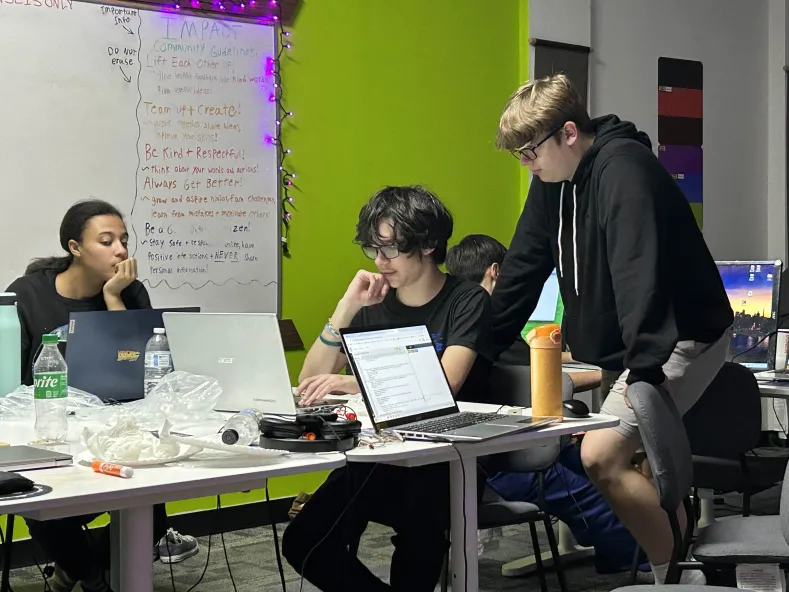 Josh helping out Julien with his project at Counterspell.