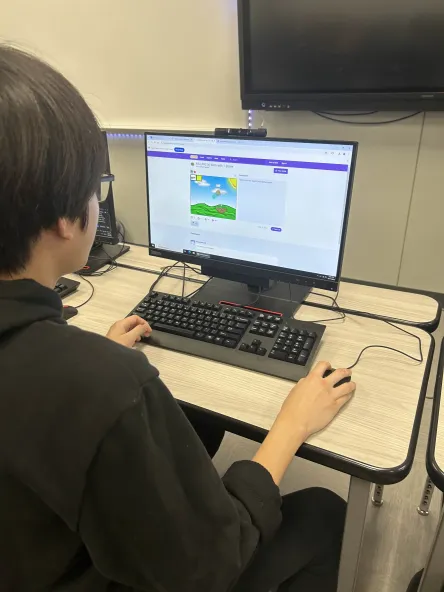 Angelo coding at a Meeting.